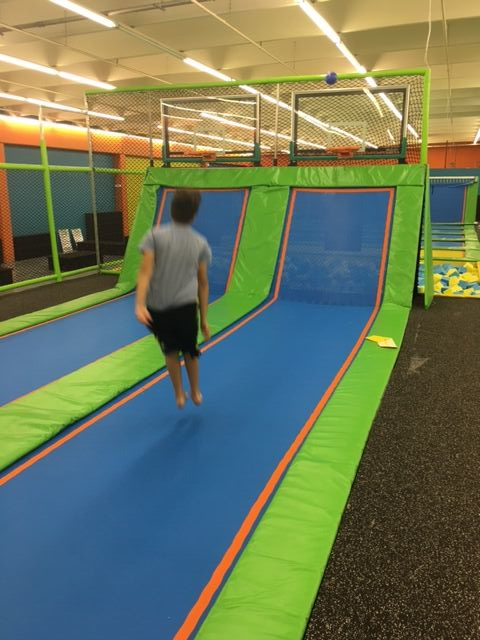 Indoor trampoline park with basketball